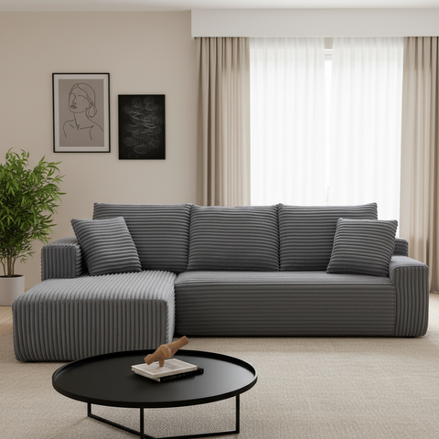 Gray sectional sofa in a living room with a black coffee table and decorative items.