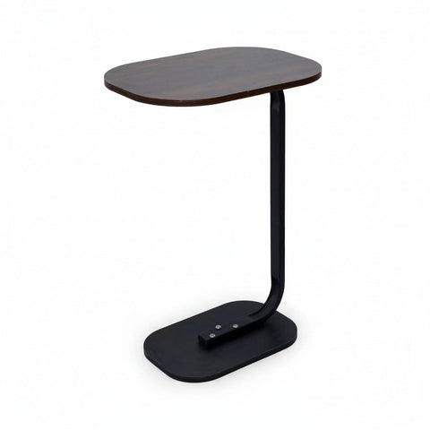 Black side table with a wooden top on a white background